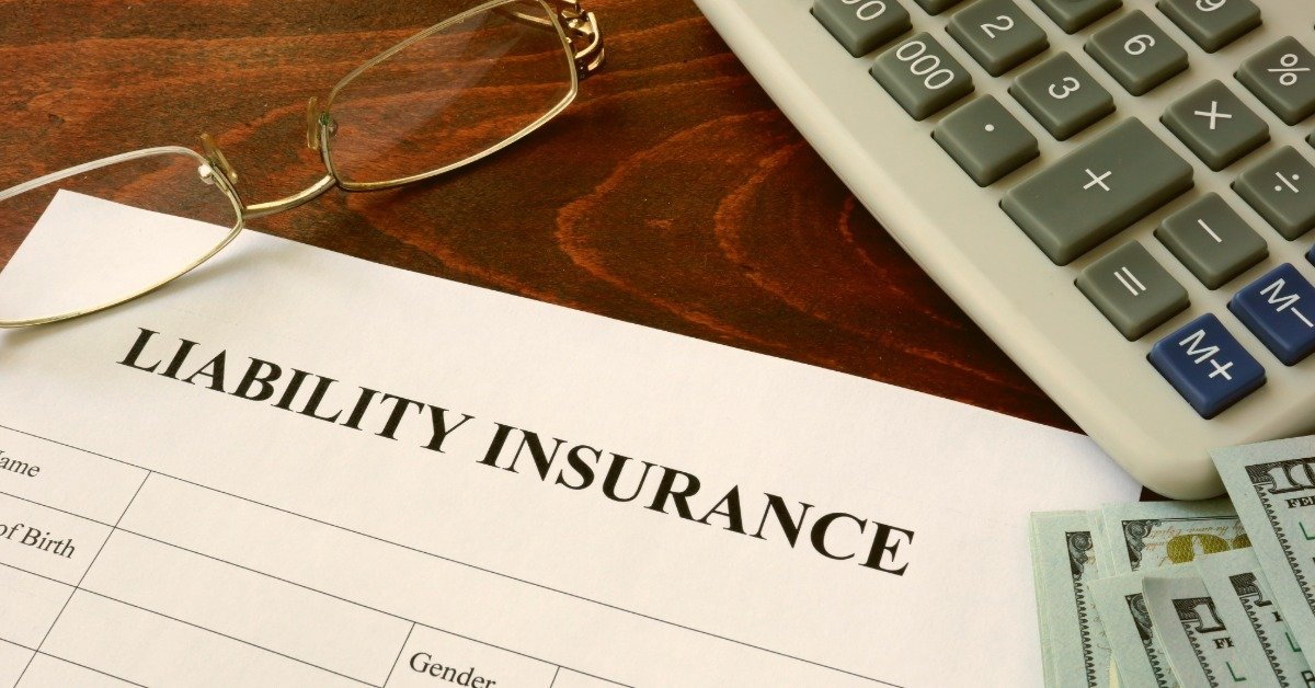 Liability insurance form and dollars on the table.